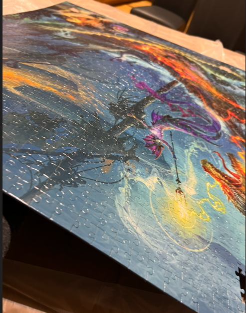 The black part is the shadow of the lifted puzzle.